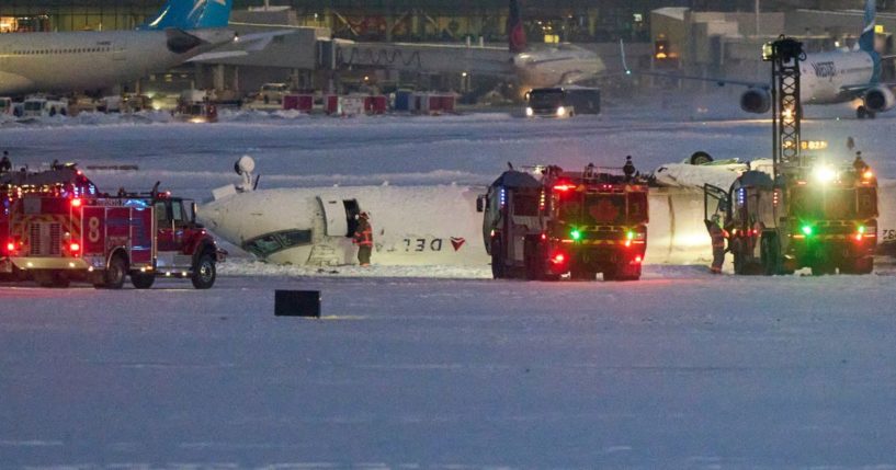 A Delta airlines plane sits on its roof after crashing upon landing at Toronto Pearson Airport in Toronto, Ontario, on Monday.