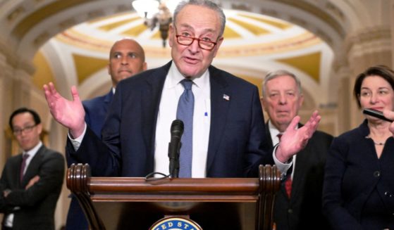 Then-Senate Majority Leader Chuck Schumer, center, along with Sen. Cory Booker, left; then-Democratic majority whip Dick Durbin, second from right; and Sen. Amy Klobuchar, right, speaks with reporters at the US Capitol in Washington, D.C., on Dec. 3.