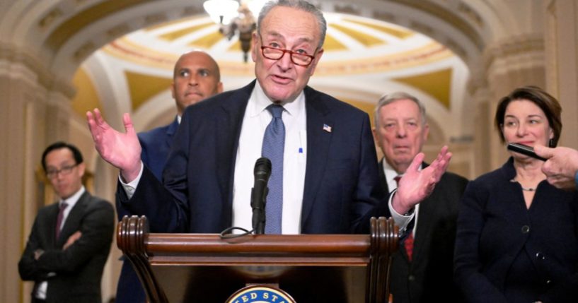 Then-Senate Majority Leader Chuck Schumer, center, along with Sen. Cory Booker, left; then-Democratic majority whip Dick Durbin, second from right; and Sen. Amy Klobuchar, right, speaks with reporters at the US Capitol in Washington, D.C., on Dec. 3.