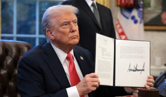 President Donald Trump signs an executive order suspending security clearances held by Peter Koski and members, partners, and employees of Covington & Burling LLP, who assisted former special counsel Jack Smith during his time as special counsel, in the Oval Office of the White House in Washington, D.C., on Tuesday.