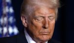 President Donald Trump bows his head in prayer at the National Prayer Breakfast in Washington, D.C., on Thursday.