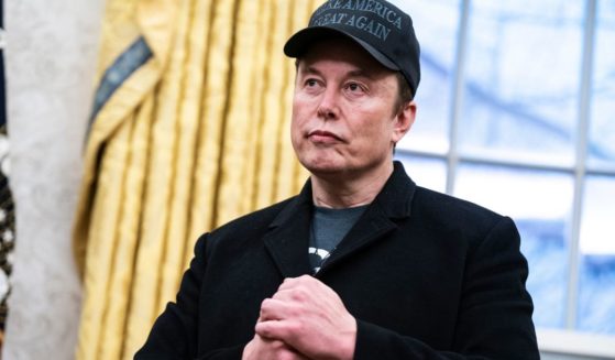 Elon Musk speaks with President Donald Trump and reporters in the Oval Office at the White House in Washington, D.C., on Tuesday.