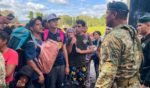 Migrants talk to Panamanian National Border Service members as they try to cross the border between Panama and Costa Rica while trying to return to Venezuela on Tuesday.