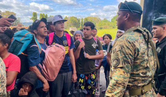 Migrants talk to Panamanian National Border Service members as they try to cross the border between Panama and Costa Rica while trying to return to Venezuela on Tuesday.