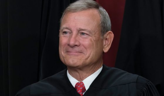 Chief Justice John Roberts joins other members of the Supreme Court as they pose for a new group portrait at the Supreme Court building in Washington, D.C., on Oct. 7, 2022.