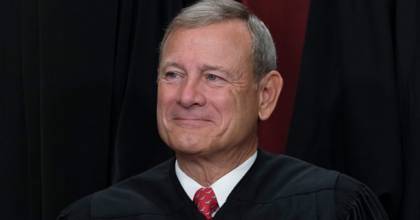 Chief Justice John Roberts joins other members of the Supreme Court as they pose for a new group portrait at the Supreme Court building in Washington, D.C., on Oct. 7, 2022.