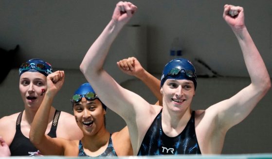 Members of Pennsylvania's 400 yard freestyle relay team, from left, Margot Kaczorowski, Hannah Kannan and Lia Thomas celebrate after winning the race at the Ivy League Women's Swimming and Diving Championships at Harvard University Feb. 19, 2022, in Cambridge, Mass. Kaczorowski is one of three former Ivy League swimmers who filed a suit against the University of Pennsylvania for allowing Thomas to swim as a female on the women's swim team after he completed for two seasons as a male on the school's men's swim team.