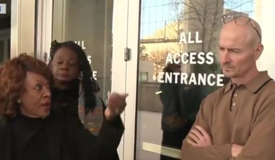 Democratic Rep. Maxine Waters of California, left, badgered an unidentified federal employee guarding the Department of Education.