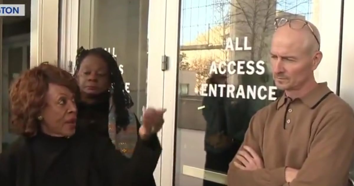 Democratic Rep. Maxine Waters of California, left, badgered an unidentified federal employee guarding the Department of Education.