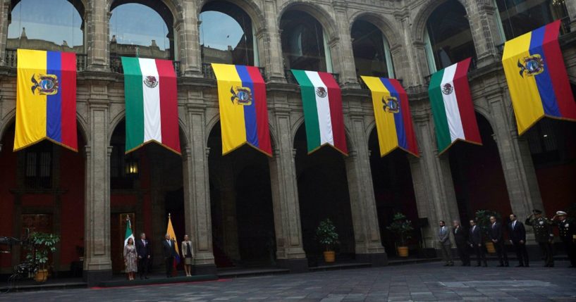 Mexican and Ecuadorean flags hang at the National Palace during a government ceremony in Mexico City on Nov. 24, 2022.