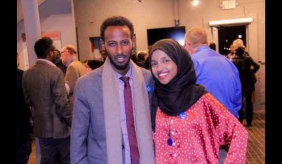 Rep. Ilhan Omar standing next to her now-ex-husband, Ahmad Hirsi.