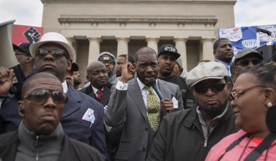 Pastor Jamal Harrison Bryant gathered with other left-wing protesters outside of City Hall in Baltimore, Maryland, on April 13, 2015.