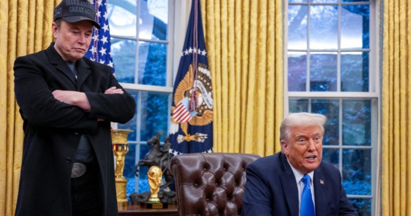 Elon Musk, left, listens as President Donald Trump, right, speaks to reporters from the Resolute desk in the Oval Office of the White House in Washington, D.C., on Tuesday.