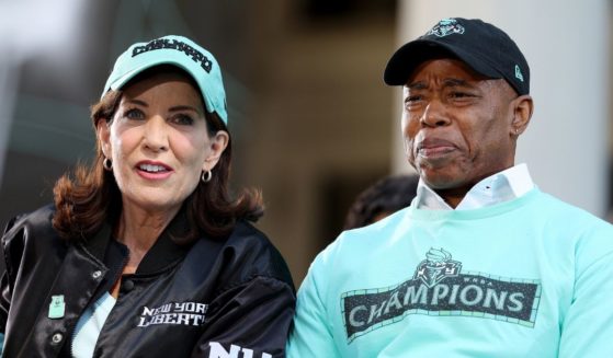 Gov. Kathy Hochul, left, and New York City Mayor Eric Adams, right, react during the Championship ticker tape parade and victory rally celebrating the New York Liberty winning the 2024 WNBA Finals in New York City on Oct. 24.