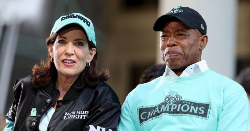 Gov. Kathy Hochul, left, and New York City Mayor Eric Adams, right, react during the Championship ticker tape parade and victory rally celebrating the New York Liberty winning the 2024 WNBA Finals in New York City on Oct. 24.