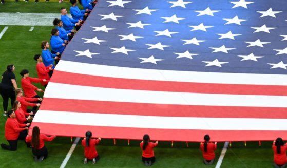 The American flag is held on the field ahead of Super Bowl LIX between the Kansas City Chiefs and the Philadelphia Eagles Sunday at State Farm Stadium in Glendale, Arizona.