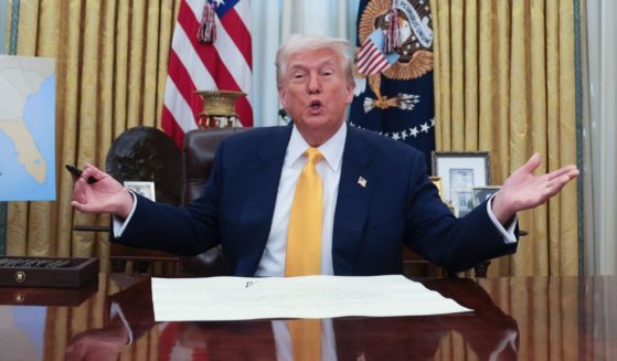 U.S. President Donald Trump answers questions after the swearing-in ceremony for Commerce Secretary Howard Lutnick in the Oval Office at the White House on February 21, 2025 in Washington, DC.