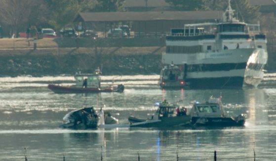 Emergency response units search the wreckage of a U.S. Army helicopter and American Airlines plane on the Potomac River on Jan. 30.