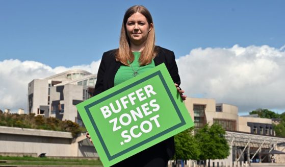 Scottish Green Party member Gillian Mackay is seen in a file photo from May 2022, holding a placard outside the Scottish Parliament in Edinburgh, Scotland, in support of the creation of buffer zones around abortion clinics.