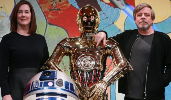 Producer Kathleen Kennedy, left, C-3PO, center, and Mark Hamill, right, attend the "Star Wars: The Last Jedi" media conference in Tokyo, Japan, on Dec. 7, 2017.