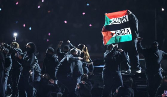 A protester holds a flag during the Apple Music Super Bowl LIX Halftime Show in New Orleans, Louisiana, on Sunday.