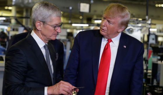 President Donald Trump, right, tours an Apple manufacturing plant in Austin, Texas, with Apple CEO Tim Cook, left, on Nov. 20, 2019.