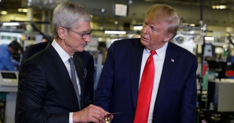 President Donald Trump, right, tours an Apple manufacturing plant in Austin, Texas, with Apple CEO Tim Cook, left, on Nov. 20, 2019.