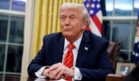 President Donald Trump reacts to a question from a reporter after signing a series of executive orders including tariffs on steel and aluminum.