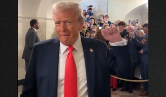 President Donald Trump pumps his fist as a group chants "USA!" after he greeted them Tuesday during the first White House tour of his second presidential term.