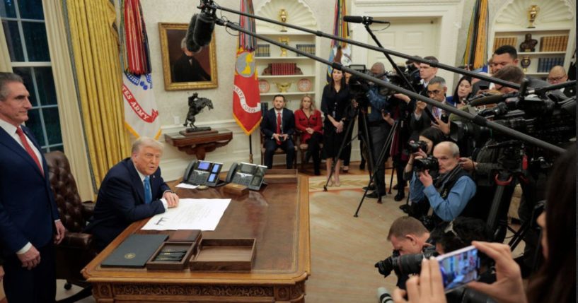 President Donald Trump, flanked by Interior Secretary Doug Burgum, left, takes questions from reporters in the Oval Office in a file photo from Jan. 31.