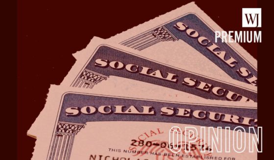 A close up photograph of three U.S. social security cards.