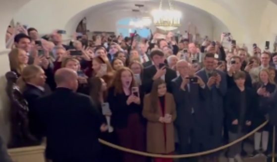 Members of the first White House tour under the second Trump administration react when President Donald Trump appears to greet them on Tuesday.