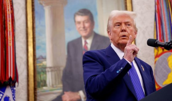 U.S. President Donald Trump gestures as he takes a question from a reporter after Tulsi Gabbard is sworn in as Director of National Intelligence in the Oval Office at the White House on February 12, 2025 in Washington, DC.