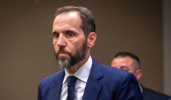 Special Prosecutor Jack Smith walks away after addressing reporters after his grand jury has issued more indictments of former President Donald Trump in Washington, DC.