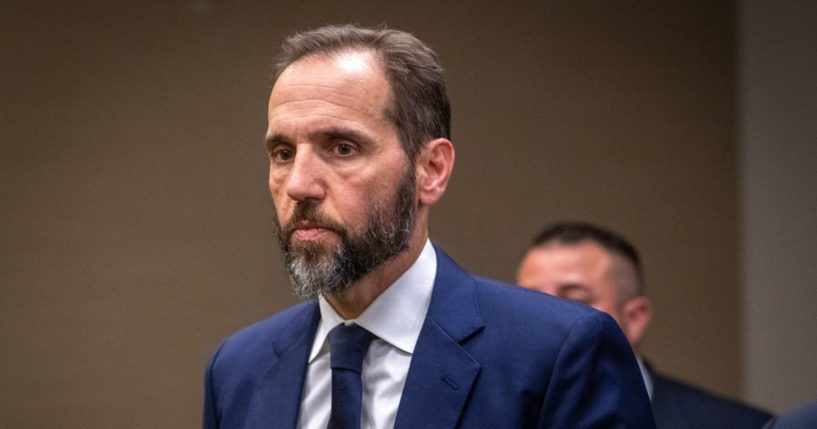 Special Prosecutor Jack Smith walks away after addressing reporters after his grand jury has issued more indictments of former President Donald Trump in Washington, DC.