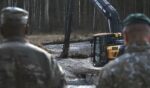 U.S. Army soldiers from the 1st Armored Brigade Combat Team, 3rd Infantry Division, along with Lithuanian Army and emergency services personnel, discuss their plan to recover four U.S. soldiers in a U.S. Army M88 Hercules submerged under several meters of water in a swamp near a training area outside Pabadre, Lithuania, on Thursday.