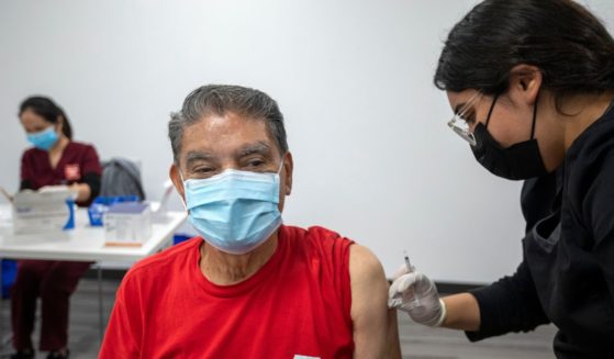 Irene Michel, right, gives Jaime Sores, left, a Covid-19 vaccination booster in Los Angeles, California, on Nov. 17, 2021.