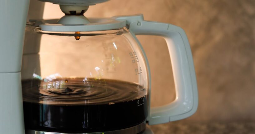 This stock image shows a pot of coffee brewing.