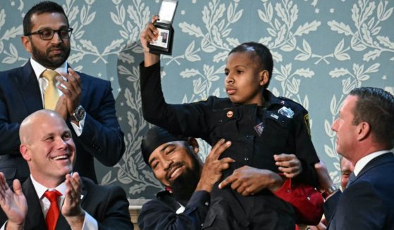 Devarjaye "DJ" Daniel is lifted up by his father Theodis Daniel upon being given credentials from U.S. Secret Service Director Sean Curran after President Donald Trump made him an honorary member of the U.S. Secret Service during his address to a joint session of Congress in Washington, D.C., on Tuesday.