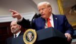 President Donald Trump, accompanied by Commerce Secretary Howard Lutnick, left, takes a question from a reporter in the Roosevelt Room of the White House in Washington, D.C., on March 3.