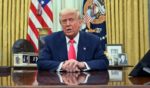 President Donald Trump speaks as he prepares to sign executive orders in the Oval Office of the White House in Washington, D.C., on Match 6.