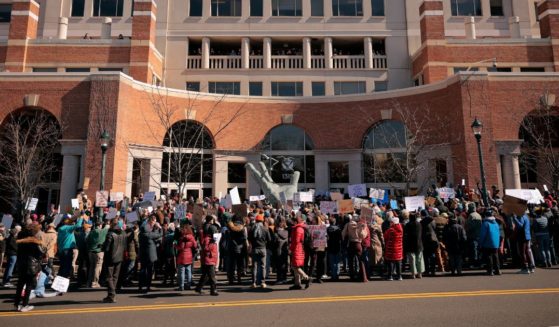 Protesters gather to protest against Department of Government Efficiency cuts outside the headquarters of the National Oceanic and Atmospheric Administration in Silver Spring, Maryland, on Monday.