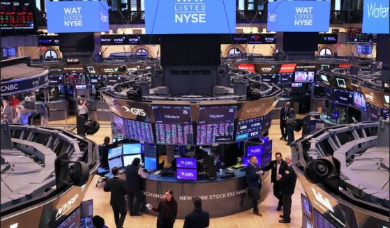 Traders work on the floor of the New York Stock Exchange in New York City in a file photo from March 4. Markets were up Wednesday after a report on inflation shared good news.