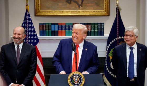 President Donald Trump, center, accompanied by Commerce Secretary Howard Lutnick, left, and Taiwan Semiconductor Manufacturing Company CEO C.C. Wei, right, speaks in the Roosevelt Room of the White House in Washington , D.C., on Monday.