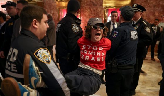 New York City Police officers arrest a protester from the group Jewish Voice for Peace, who protested inside Trump Tower in support of Columbia graduate student Mahmoud Khalil on Thursday.