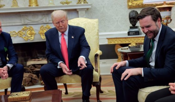 President Donald Trump, center, paused a meeting with Irish Taoiseach Micheal Martin, left, to point out the socks being worn by Vice President J.D. Vance, right.