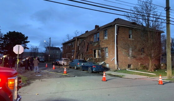 Detroit fire crews work on the scene after an apartment explosion in Detroit on Monday.