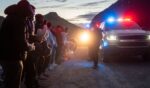 Illegal aliens from Mexico and Guatemala are apprehended by U.S. Customs and Border Patrol officers after crossing a section of border wall in Ruby, Arizona, on Jan. 4.