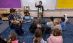 Marquez Charter Elementary School kindergarten teacher Brooke Newman works with her students in their new classroom on the campus of Nora Sterry Elementary School in Los Angeles, California, on Jan. 15.