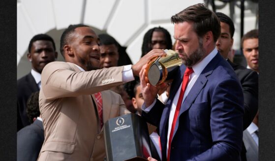 TreVeyon Henderson holds the top of the trophy as Vice President JD Vance holds the base of the trophy that separated as President Donald Trump welcomed the 2025 College Football National Champions, the Ohio State University football team, to the White House, Monday.